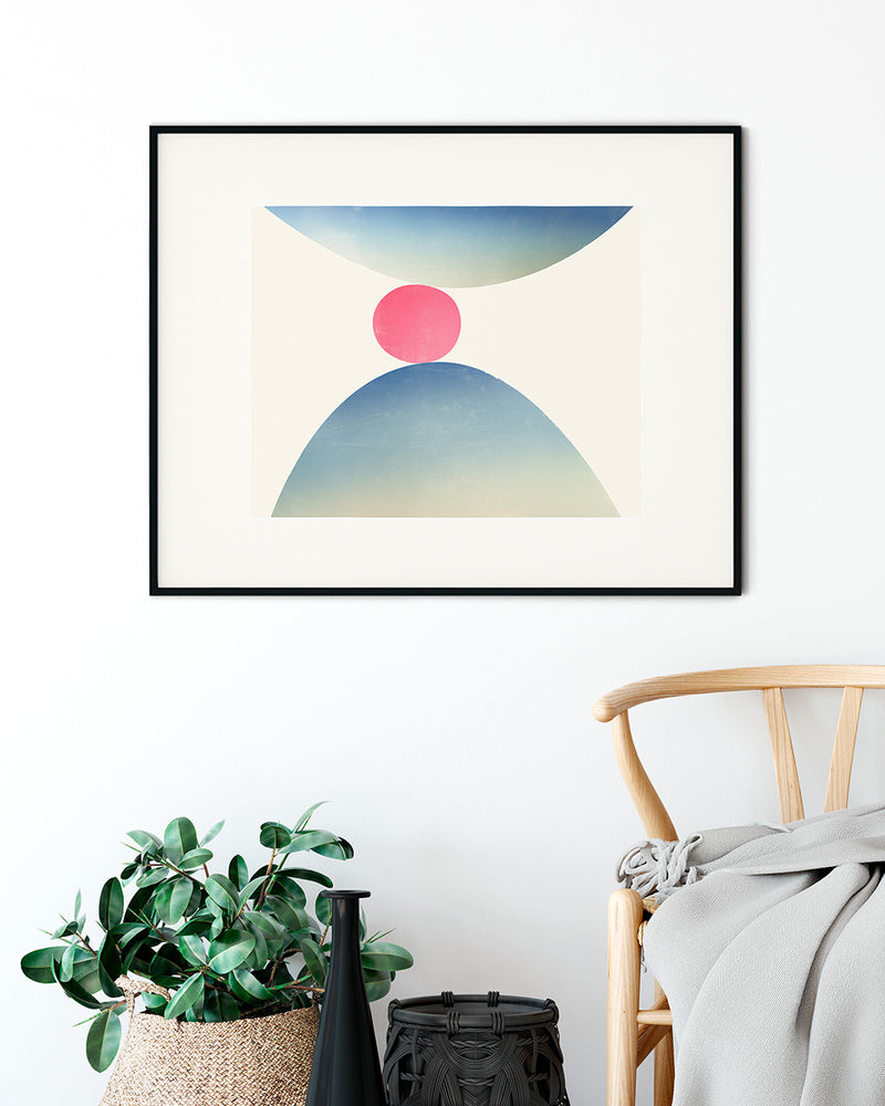 Black framed print of Spring, a modern graphic fine art print by Janet Taylor, hanging in a styled room with a chair and plant.
